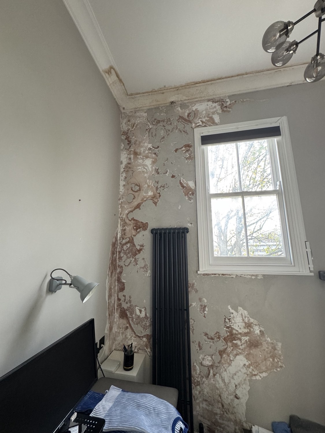 TLC room before reinstatement, with damaged wall finishes following a boiler leak