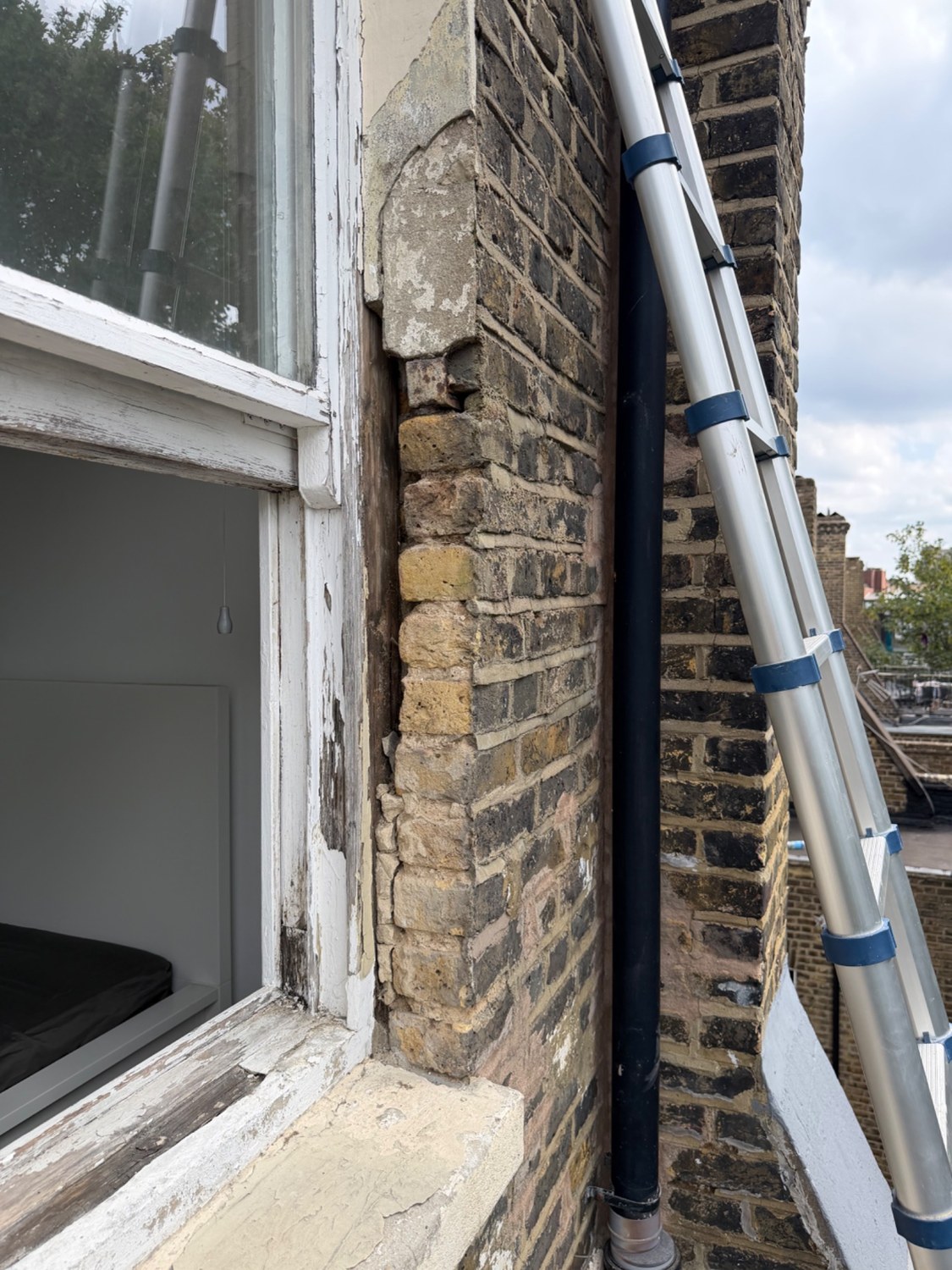 Damaged external window surround before TLC local repairs